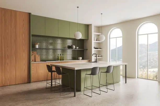 Modern kitchen with green cabinets, large island, and minimalist design. -kitchen remodel contractor