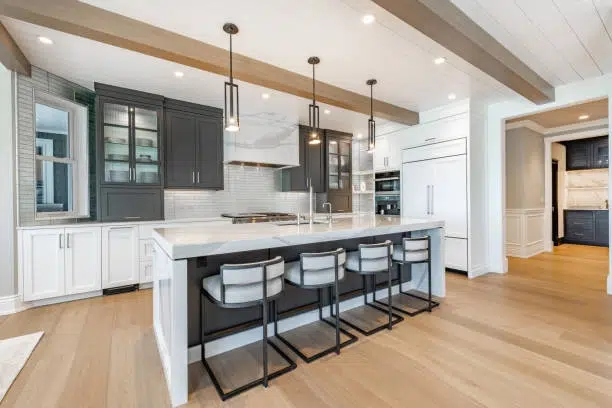 Modern kitchen with sleek countertops, pendant lighting, and wood beams. -kitchen remodel for small kitchen