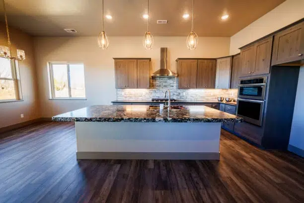 Spacious kitchen featuring dark wood cabinets, island, and granite countertops. -kitchen remodel for small kitchen