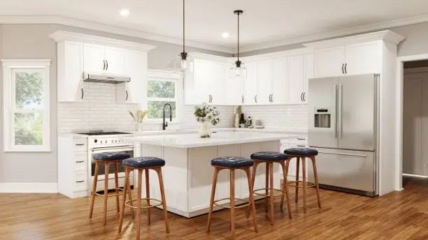 Bright kitchen with white cabinets, island seating, hardwood floors, pendant lighting. -kitchen remodeling services