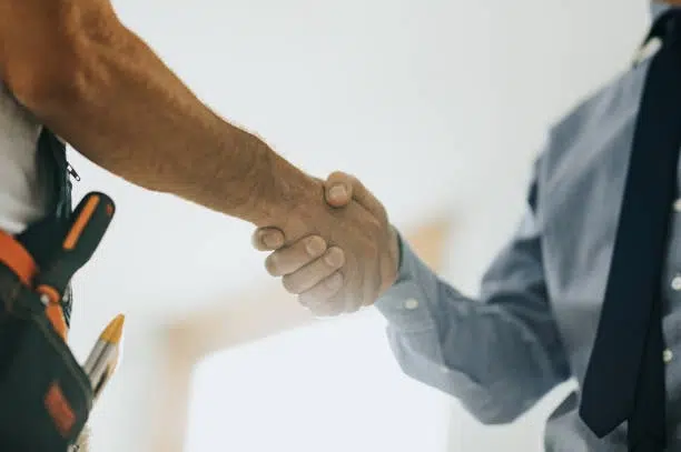 Handshake between contractor and client, symbolizing trust, agreement, and partnership. -general contractor remodeling