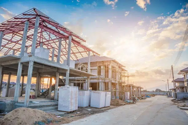Large concrete-framed houses under construction, showing new construction homes in California.