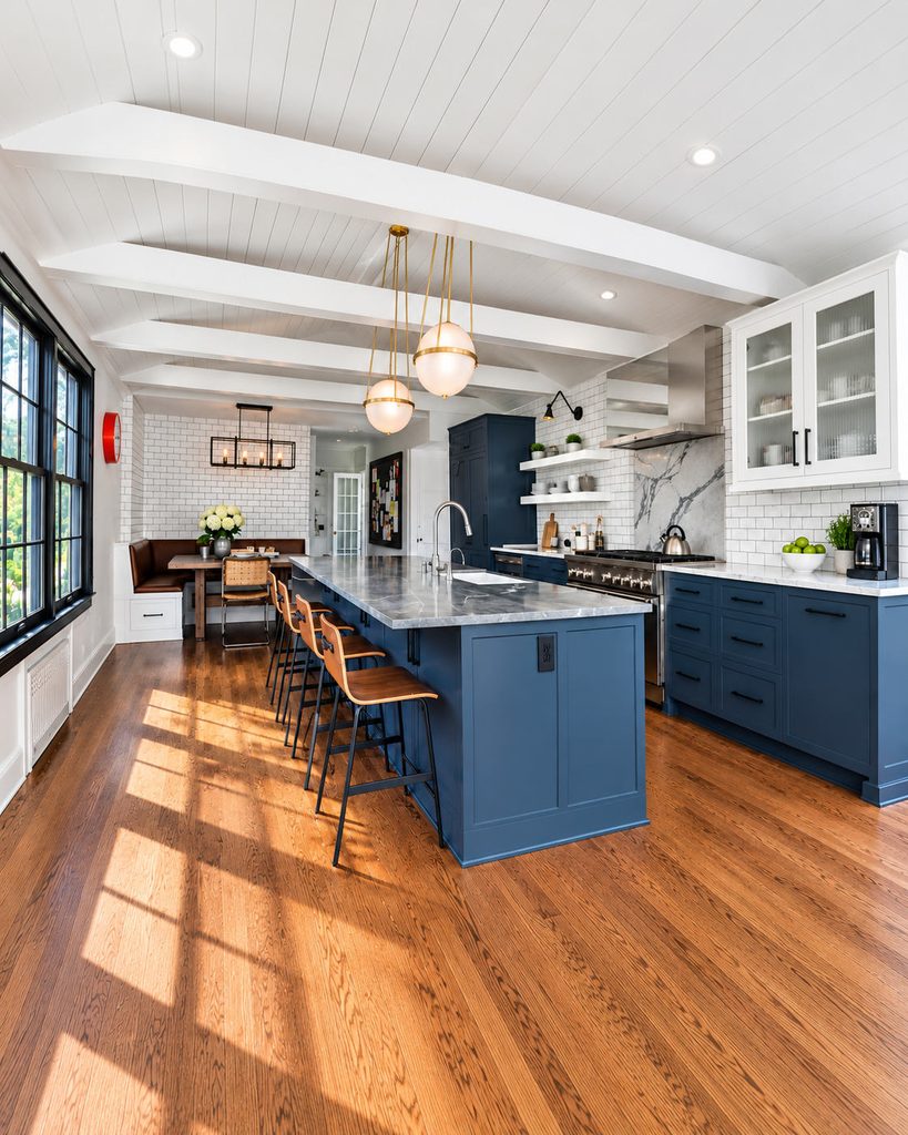 ADU kitchen with blue cabinetry, a breakfast bar and exposed ceiling beams