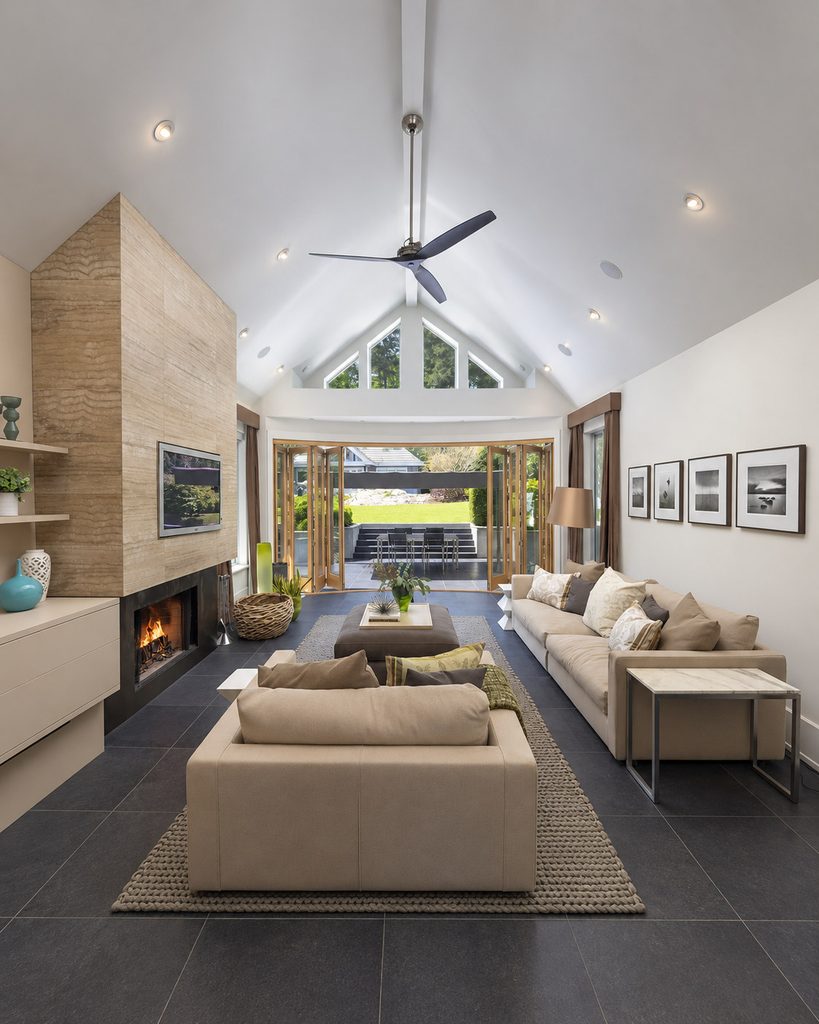 Spacious living room in the Bay Area with a vaulted ceiling, fireplace and folding patio doors